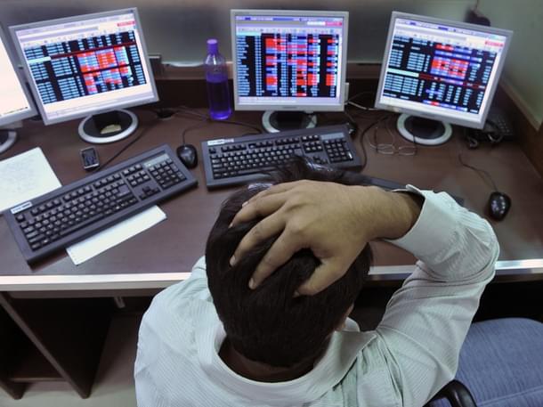 An Indian stockbroker reacts as he watches share prices on his computer during intraday trade at a brokerage firm in Mumbai on August 3, 2011. Indian shares slid as much as 1.23 percent and below the 18,000-point level in early trade August 3, tracking regional markets on concerns of a weakening global outlook. The benchmark 30-share Sensex index on the Bombay Stock Exchange fell 223.32 points to a day’s low of 17,886.57, before recovering marginally to 17,943.47 but still down 0.92 percent. AFP PHOTO/Indranil MUKHERJEE (Photo credit: INDRANIL MUKHERJEE/AFP/GettyImages)